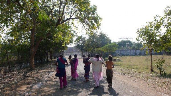 ユニオンカーバイド工場事故跡地の木にたわわに実る果実をとって帰る女性たちの群れ